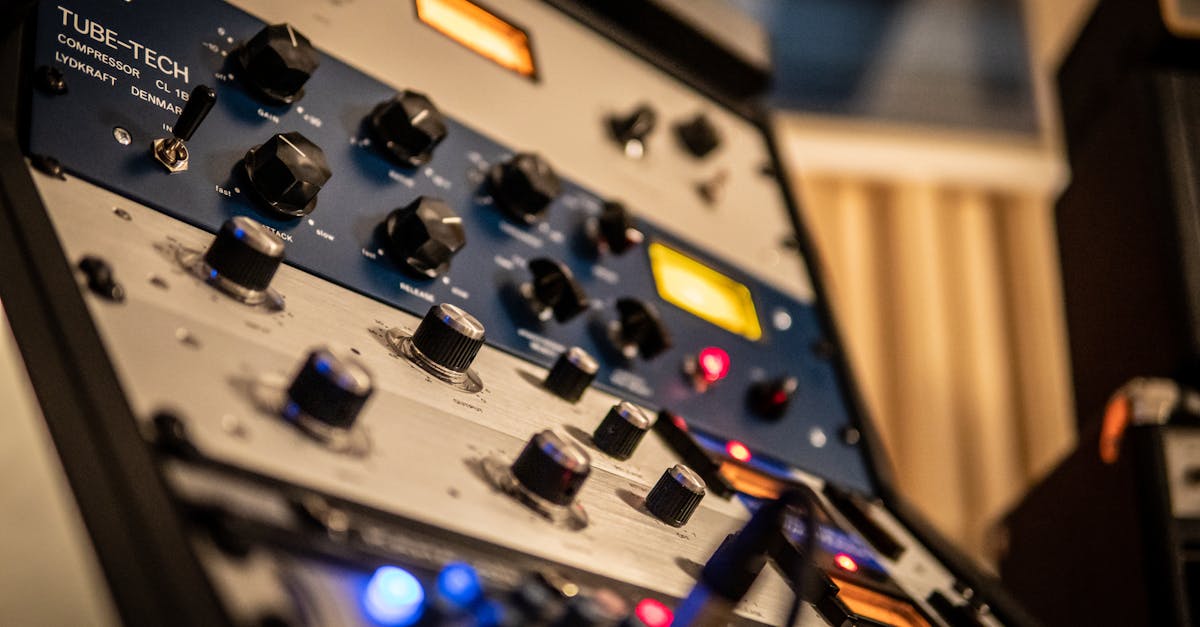 Detailed view of knobs on a Tube-Tech audio compressor in a studio setting.